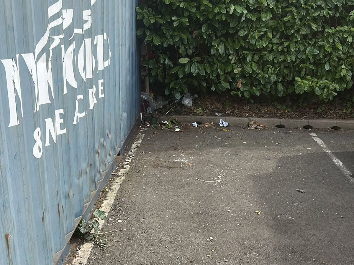 Clear, empty car park bay after fly tipped furniture was removed in Birmingham