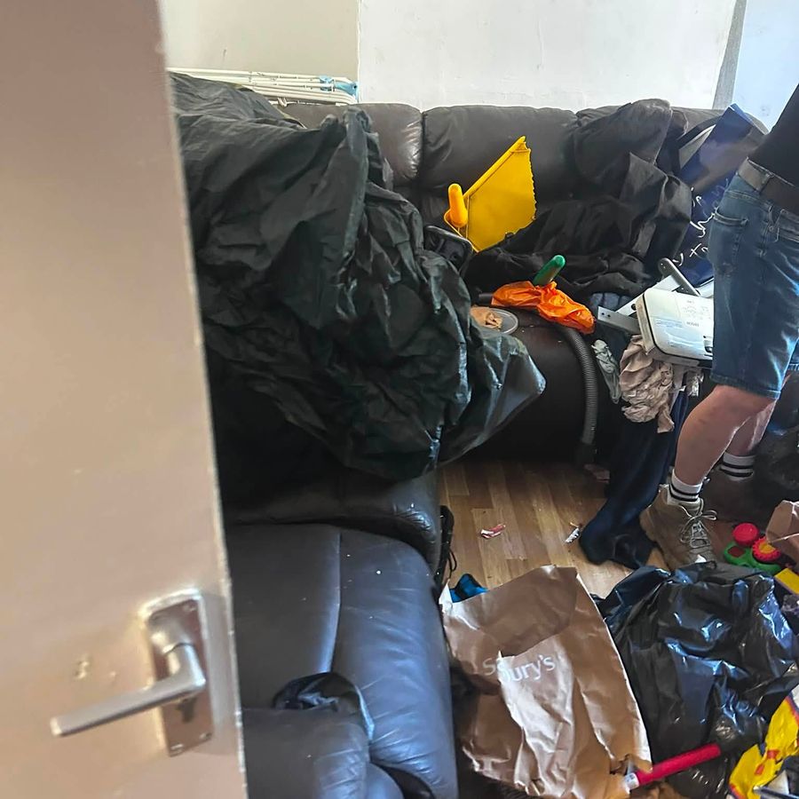 Household furniture and waste being lifted out during a clearance